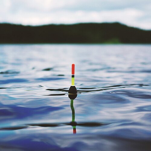 Foto van een meer met een dobber in het water